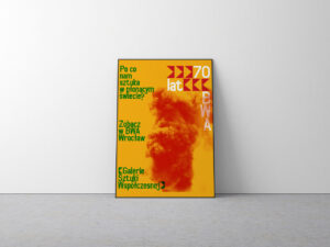 Oparty o ścianę oprawiony plakat w żółto czerwonej tonacji.
